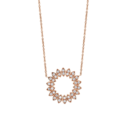 Close view of the eighteen diamond-set petals of a 14K rose gold natural diamond circle pendant.