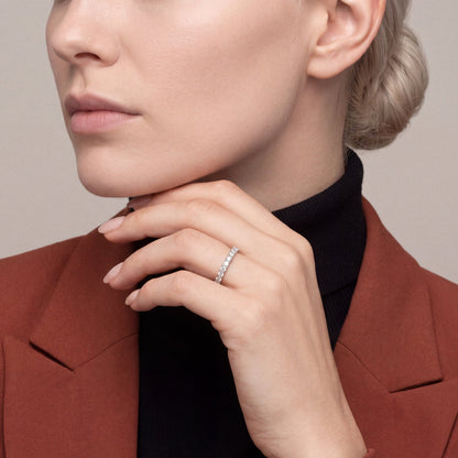 Model in a rust blazer and black turtleneck wearing a 1.71 ct tw natural diamond full eternity ring in 14K white gold