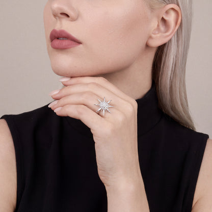 Woman in a black sleeveless funnel-neck top wearing a 0.45 ct natural diamond starburst ring in 14K white gold, hand resting under the jaw