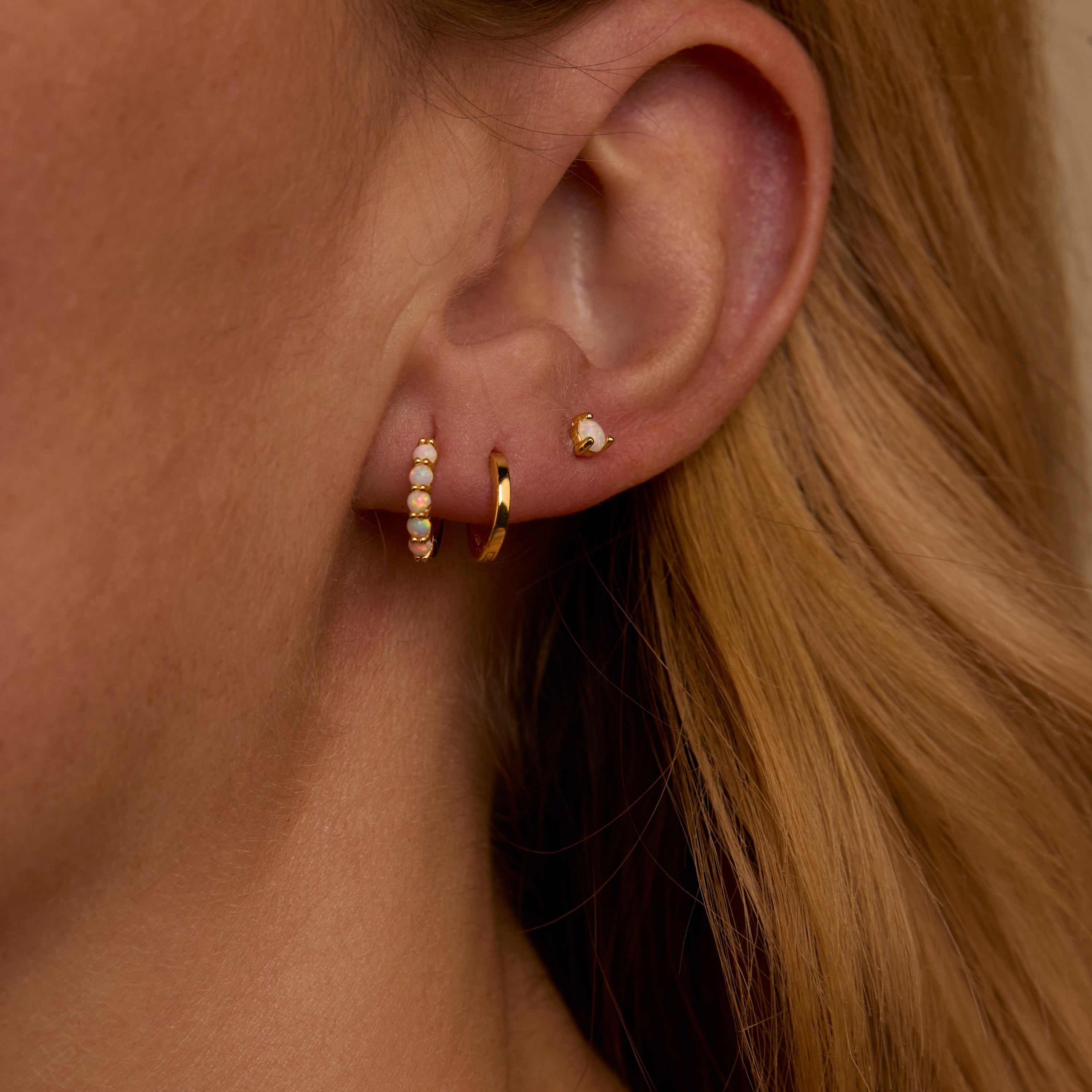 Macro detail of the Opal Hoops Studs Earring Set: Opal set in 18K Gold Vermeil. No green marks, handmade jewelry.