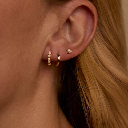 Macro detail of the Opal Hoops Studs Earring Set: Opal set in 18K Gold Vermeil. No green marks, handmade jewelry.