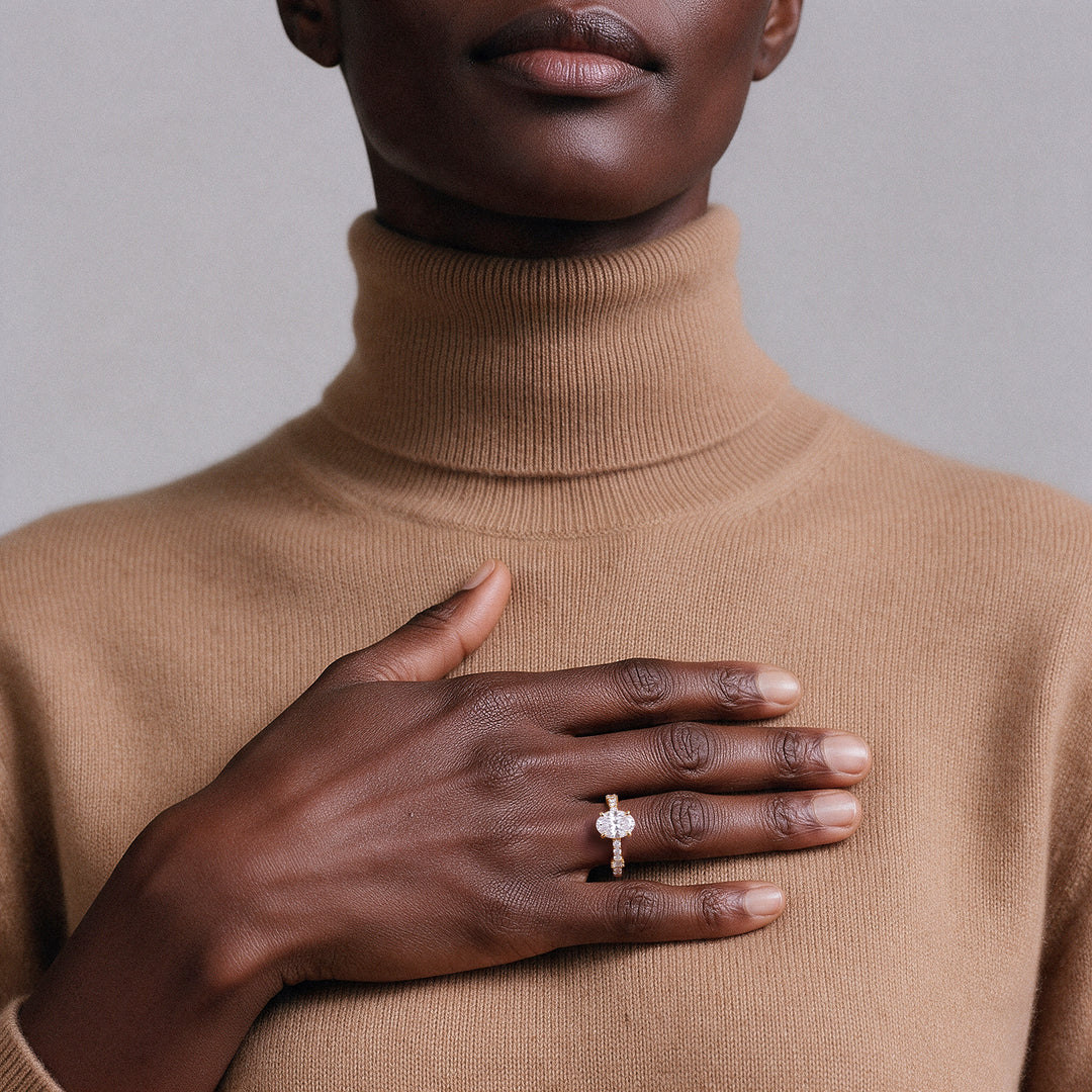 Oval solitaire ring in 14K solid gold worn on the ring finger