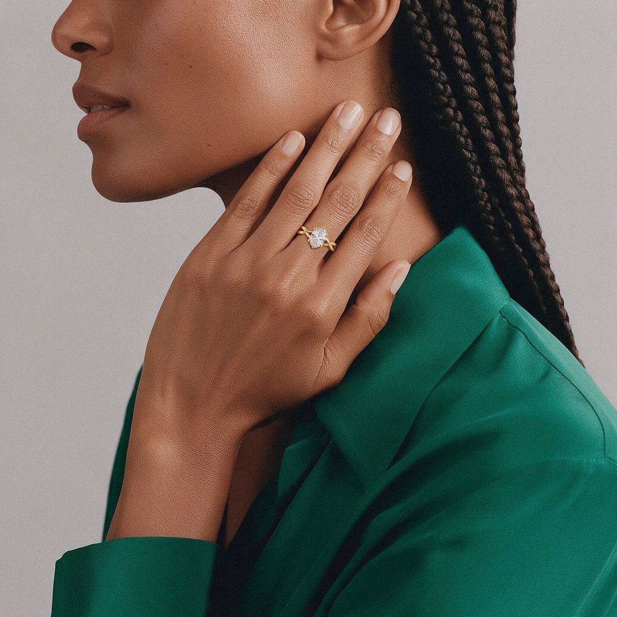 Oval solitaire twist ring in 14K solid gold worn on the hand