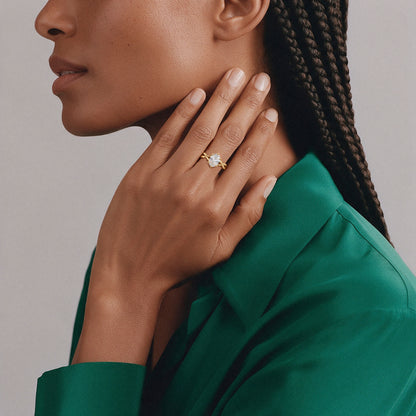 Oval solitaire twist ring in 14K solid gold worn on the hand
