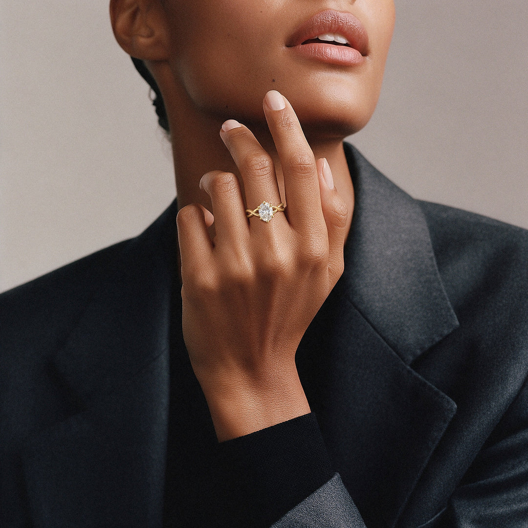 14K solid gold oval CZ engagement ring with a twisted band worn on the hand