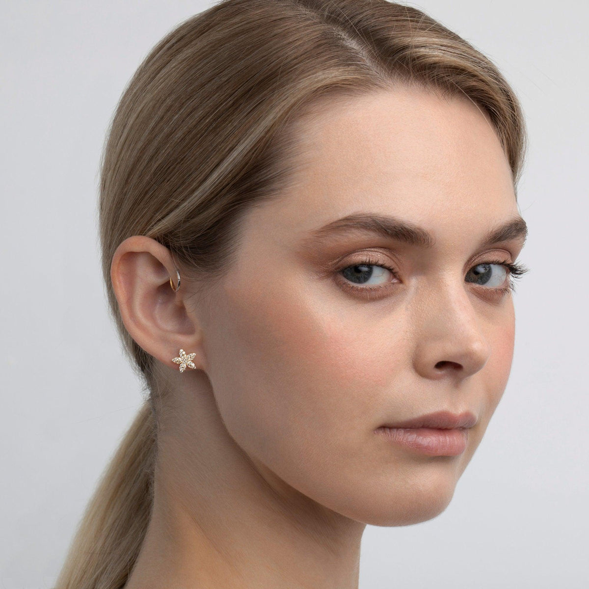 The Pavé Flower Stud Earrings styled in 18K Gold Vermeil — elegant everyday jewelry. Hypoallergenic for sensitive ears.