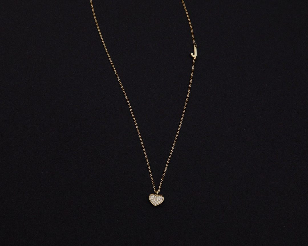 Macro detail of the Pavé Heart Initial Necklace: CZ Diamond set in 18K Gold Vermeil. Tarnish-resistant, handmade jewelry.