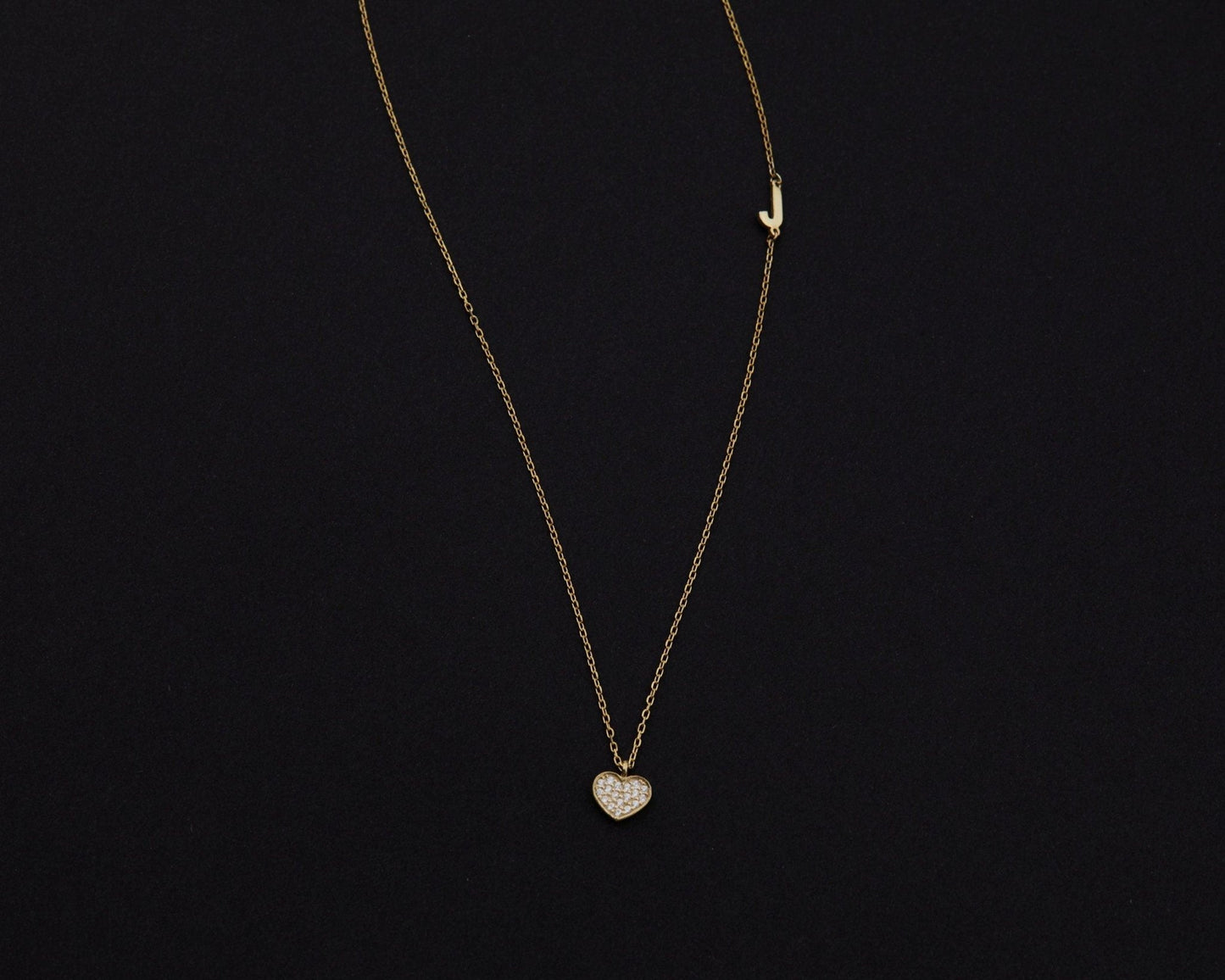 Macro detail of the Pavé Heart Initial Necklace: CZ Diamond set in 18K Gold Vermeil. Tarnish-resistant, handmade jewelry.