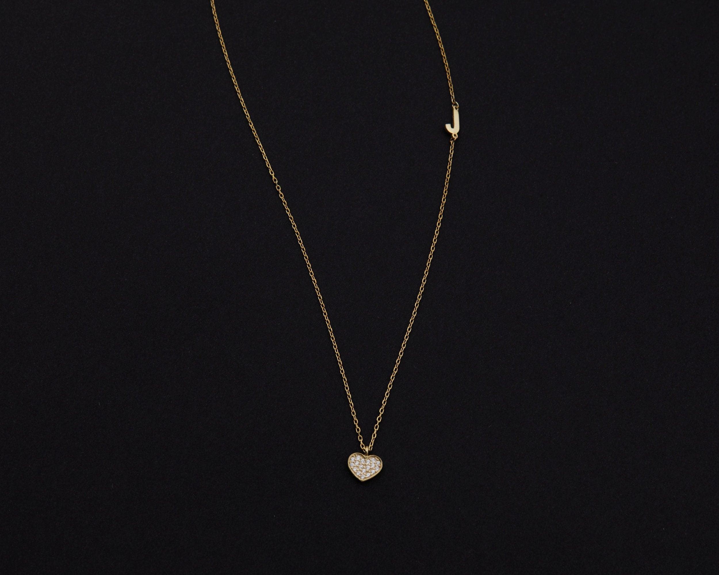 Macro detail of the Pavé Heart Initial Necklace: CZ Diamond set in 18K Gold Vermeil. Tarnish-resistant, handmade jewelry.
