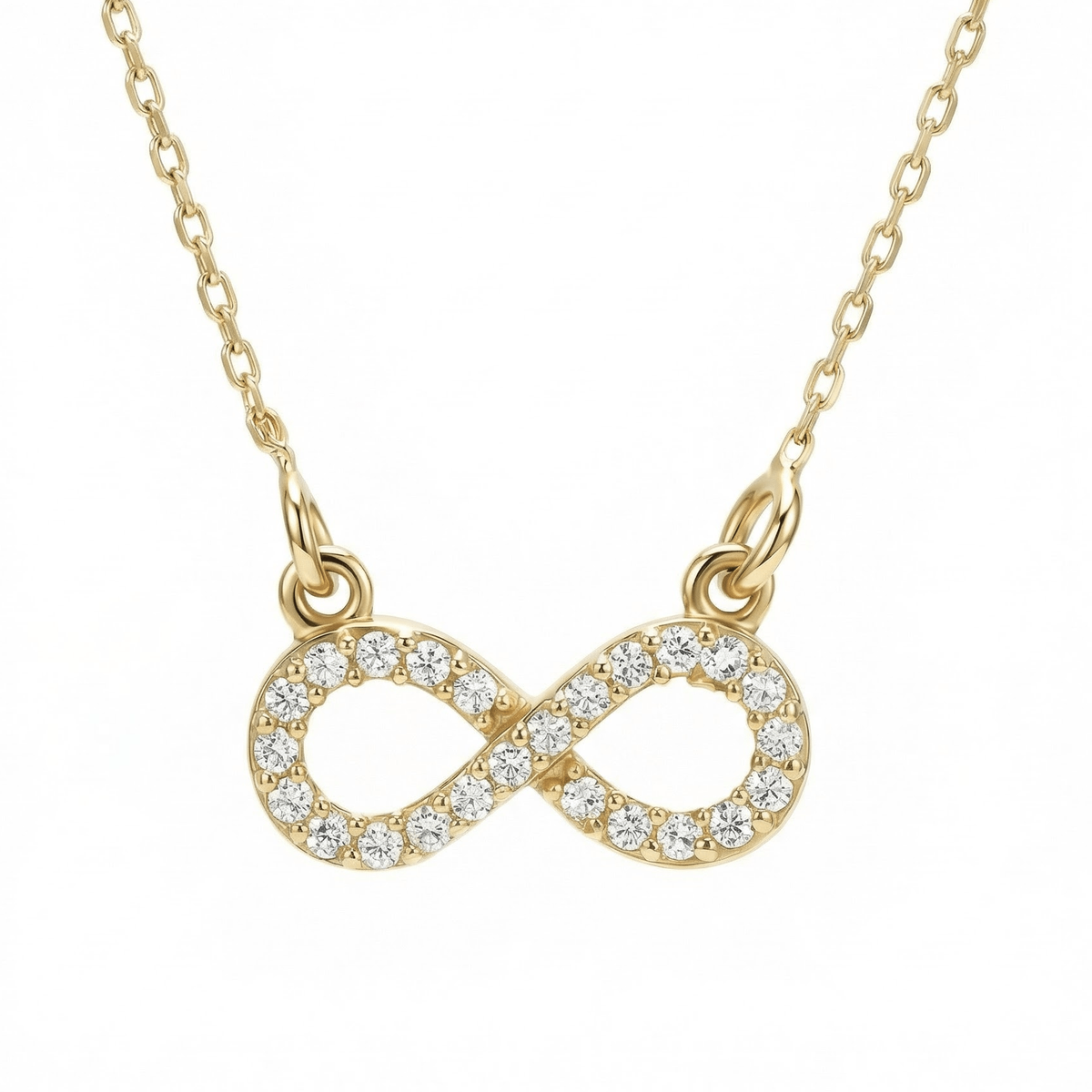 Pavé infinity pendant necklace in 14K solid gold, the infinity paved in clear CZ stones and linked to the chain at both ends.