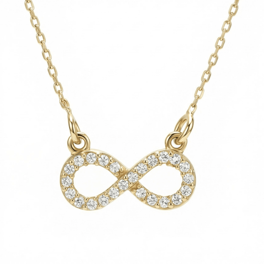 Pavé infinity pendant necklace in 14K solid gold, the infinity paved in clear CZ stones and linked to the chain at both ends.