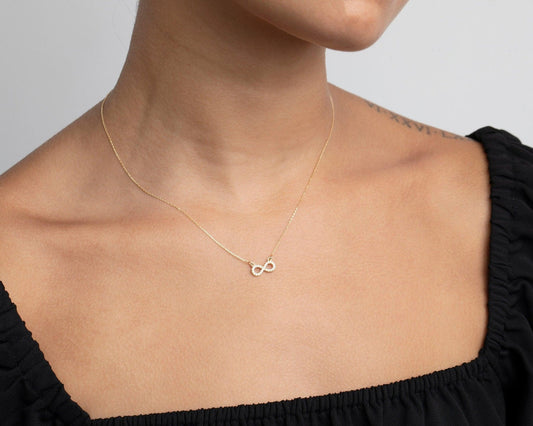 Close detail of the Pavé Infinity Pendant Necklace in 18K Gold Vermeil with CZ Diamond. Safe for sensitive skin, premium.
