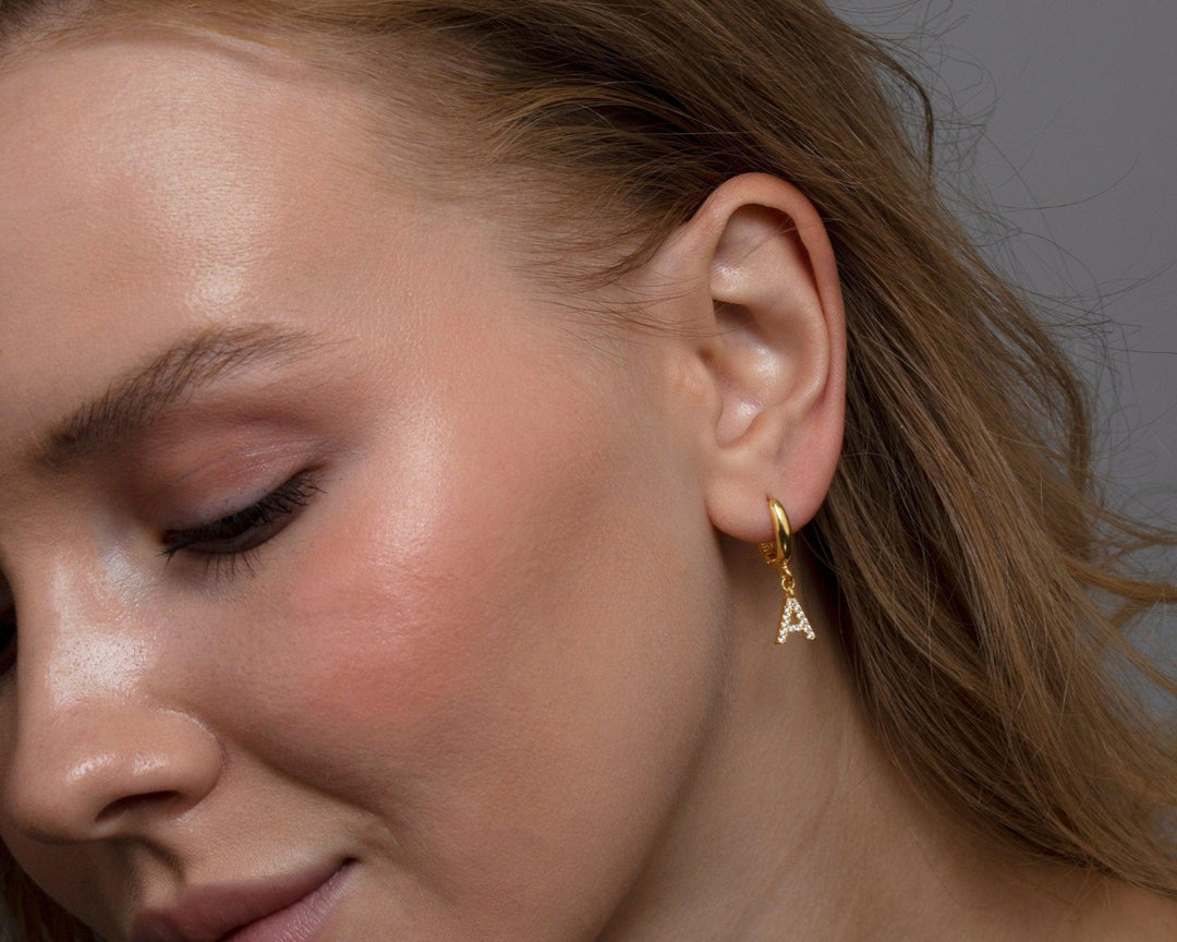 Macro detail of the Pavé Initials Letter Earrings: CZ Diamond set in 18K Gold Vermeil. No green marks, handmade jewelry.
