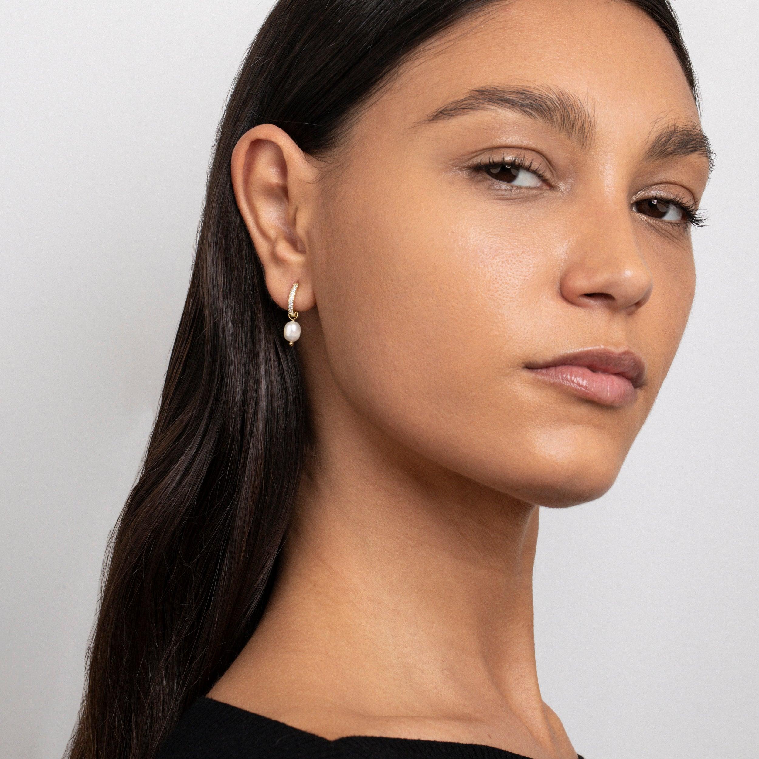 Close detail of the Dainty Pearl Hoop Earrings in Gold-Plated Steel with Freshwater Pearl and CZ Diamond.