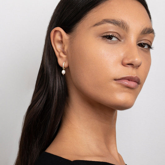 Close detail of the Dainty Pearl Hoop Earrings in Gold-Plated Steel with Freshwater Pearl and CZ Diamond.