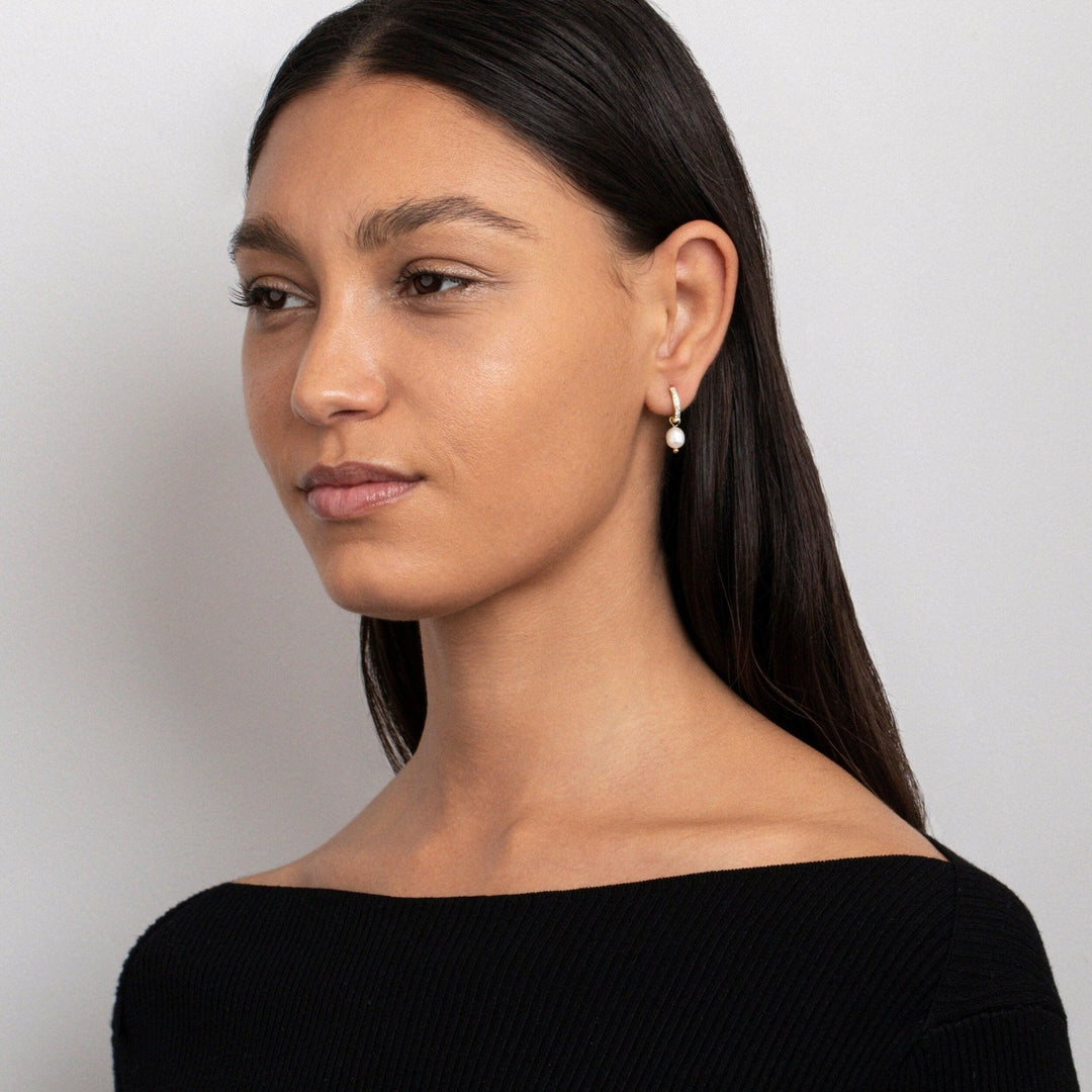 The Dainty Pearl Hoop Earrings styled in Gold-Plated Steel — elegant everyday jewelry. Hypoallergenic for sensitive ears.
