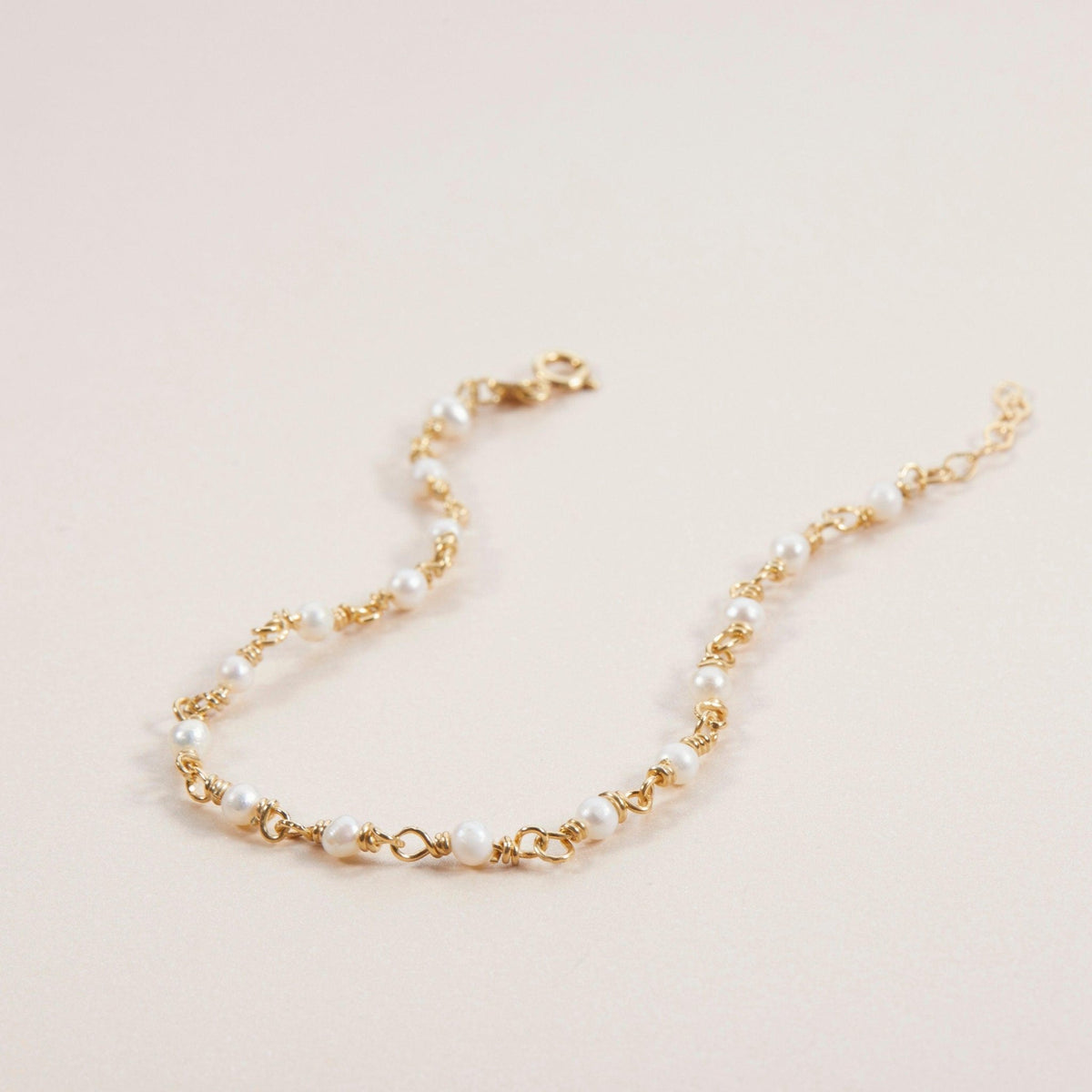 Macro detail of the Pearl Chain Bracelet: Freshwater Pearl set in 18K Gold Vermeil. Tarnish-resistant, handmade jewelry.