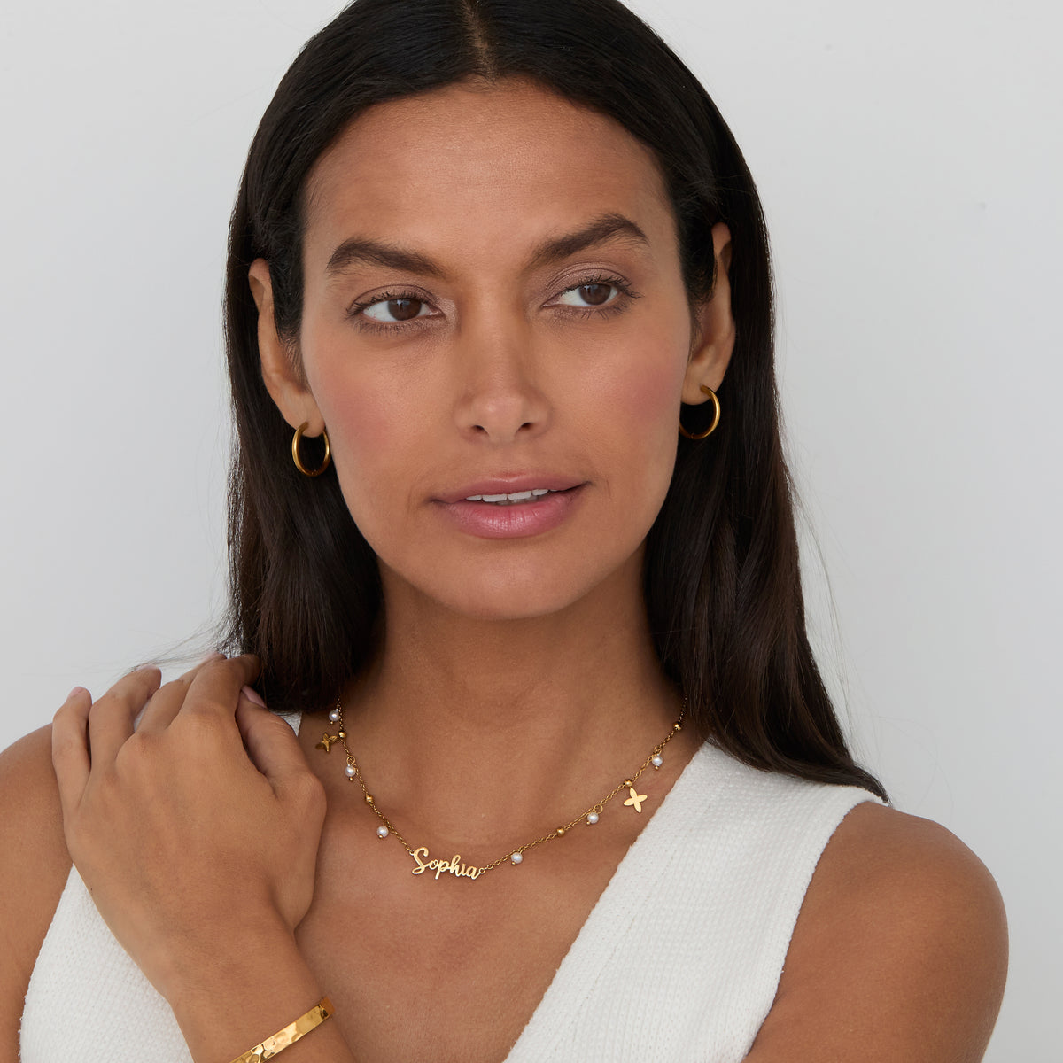 Personalized pearl name necklace with gold petal charms and a gold cuff — gift for her.