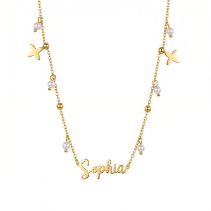 Pearl Name Necklace with Gold Petal Charms — gold script nameplate with pearl drops and gold beads.
