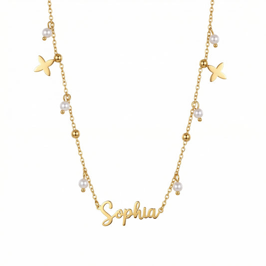 Pearl Name Necklace with Gold Petal Charms — gold script nameplate with pearl drops and gold beads.