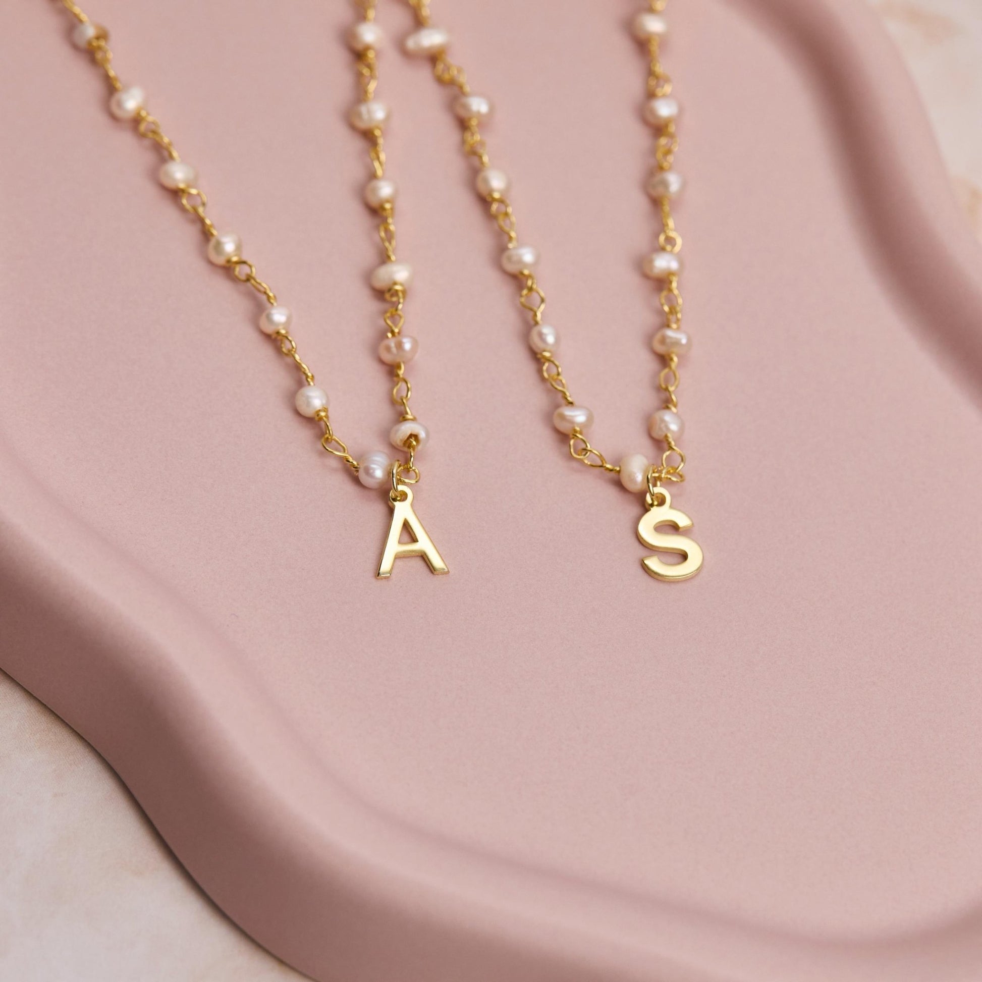 Macro detail of the Personalized Initial Pearl Necklace: Freshwater Pearl set in 18K Gold Vermeil. Tarnish-resistant.