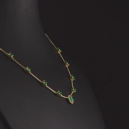 360 degree video of the emerald and natural diamond halo station necklace in 14K yellow gold