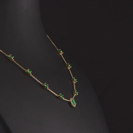 360 degree video of the emerald and natural diamond halo station necklace in 14K yellow gold
