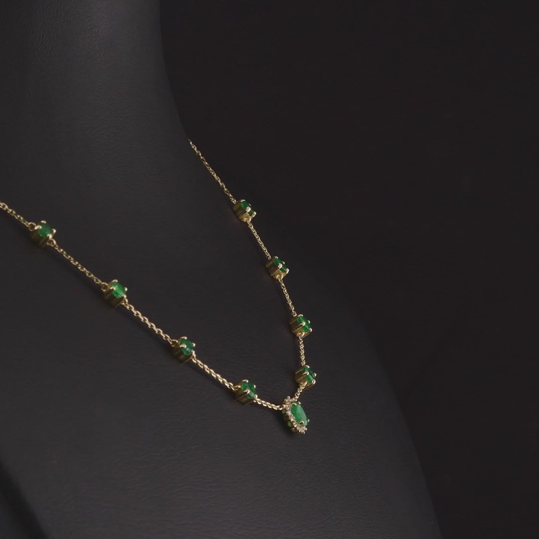 360 degree video of the emerald and natural diamond halo station necklace in 14K yellow gold