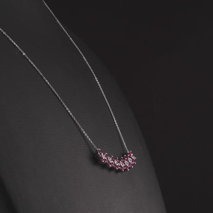 360 degree video of the ruby and natural diamond flower bar necklace in 14K white gold