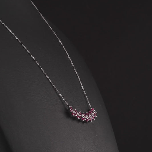 360 degree video of the ruby and natural diamond flower bar necklace in 14K white gold