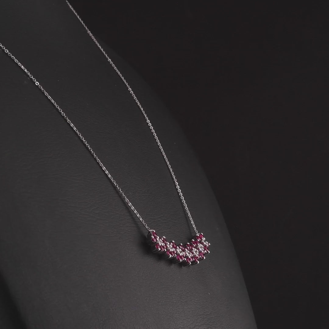 360 degree video of the ruby and natural diamond flower bar necklace in 14K white gold