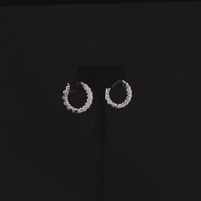 360-degree video of the round natural diamond huggie hoop earrings in 14K white gold