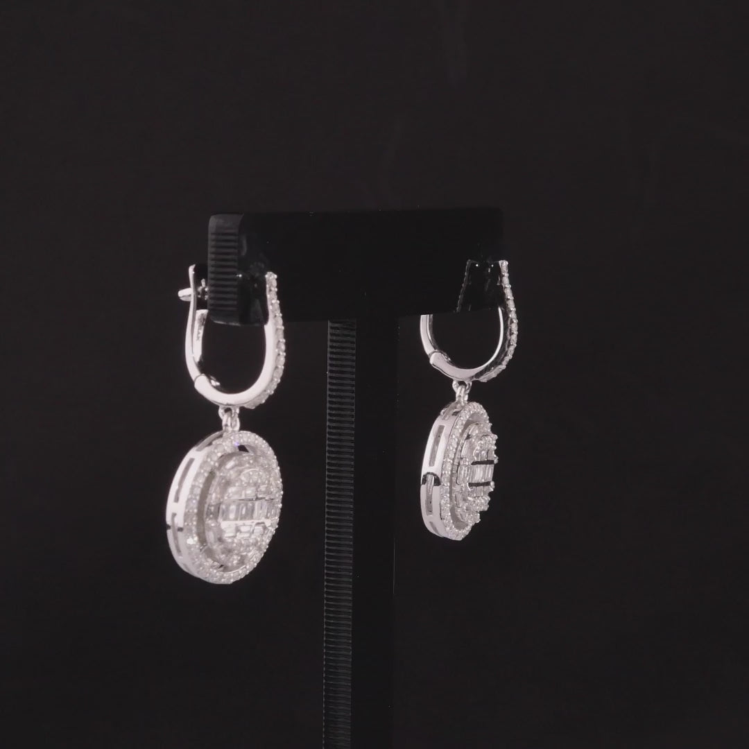 360-degree video of the natural diamond halo disc drop huggie earrings in 14K white gold.