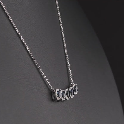 360 degree video of the marquise natural sapphire and diamond halo necklace in 14K white gold