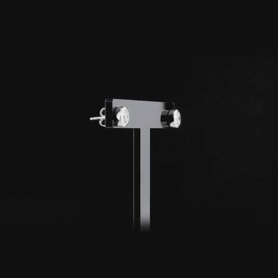 360-degree video of the bezel-set round natural diamond solitaire stud earrings in 14K white gold