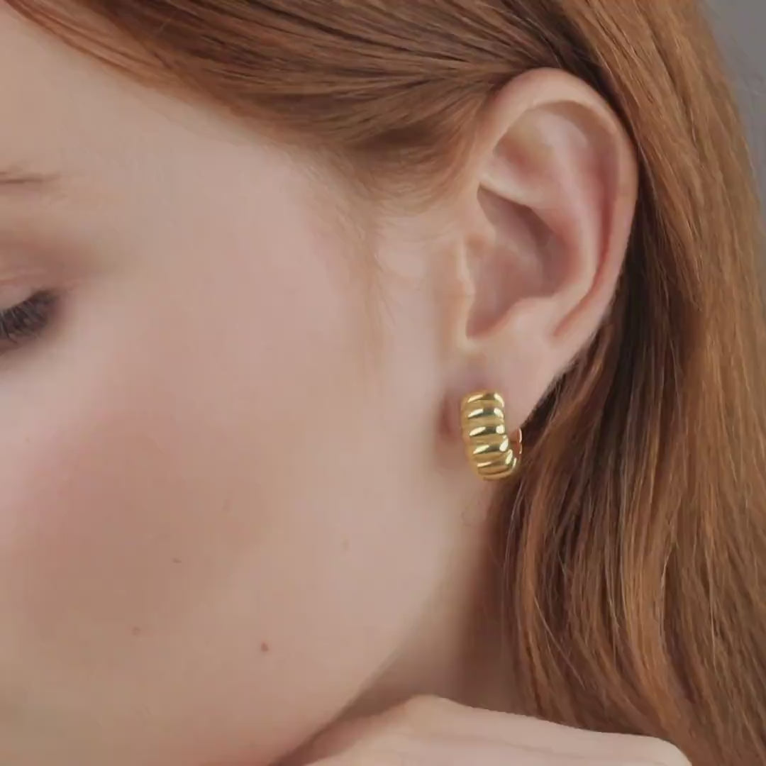 Video of chunky croissant gold hoop earring being worn, close-up ear view, 18K gold vermeil