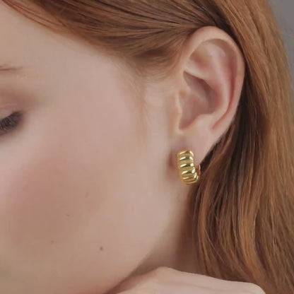 Video of chunky croissant gold hoop earring being worn, close-up ear view, 18K gold vermeil