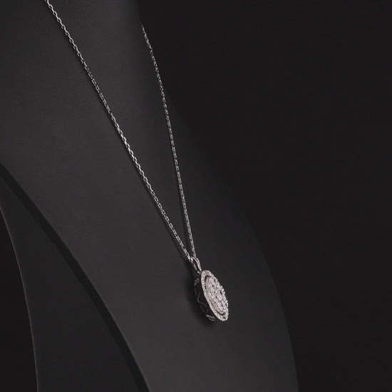 Round diamond cluster halo pendant in 14K white gold turning 360 degrees