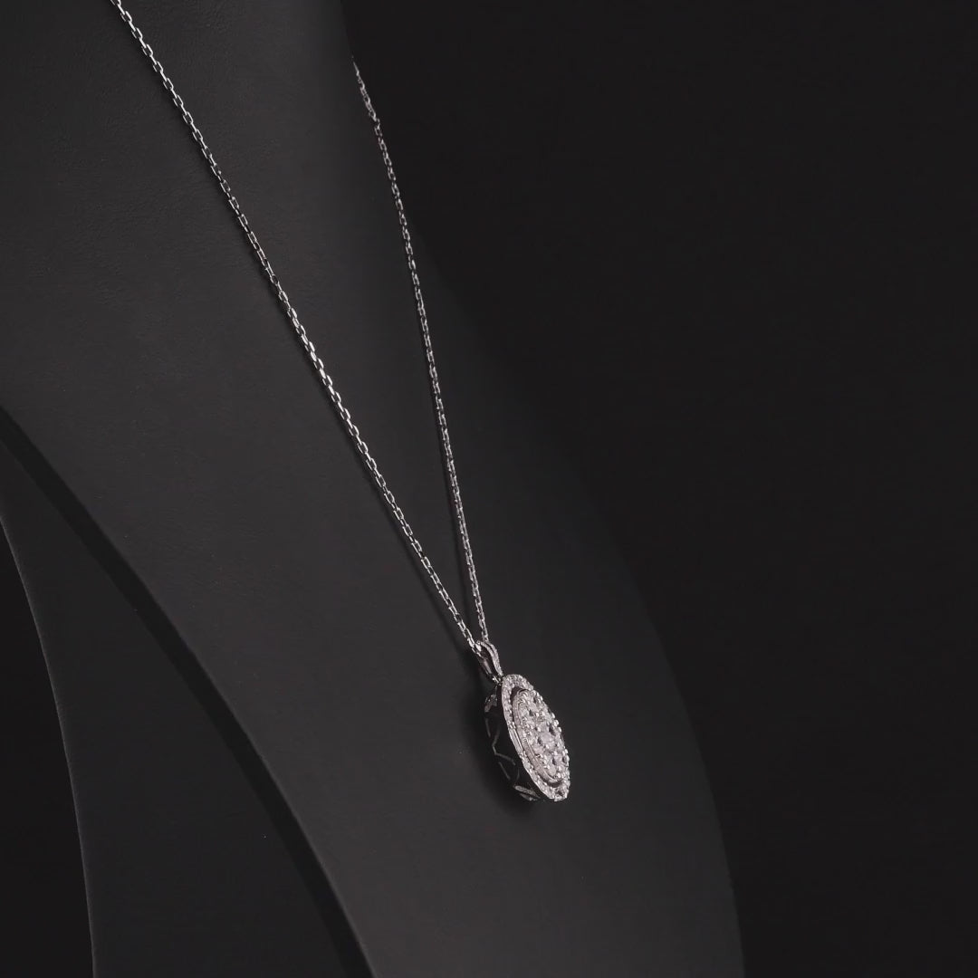 Round diamond cluster halo pendant in 14K white gold turning 360 degrees