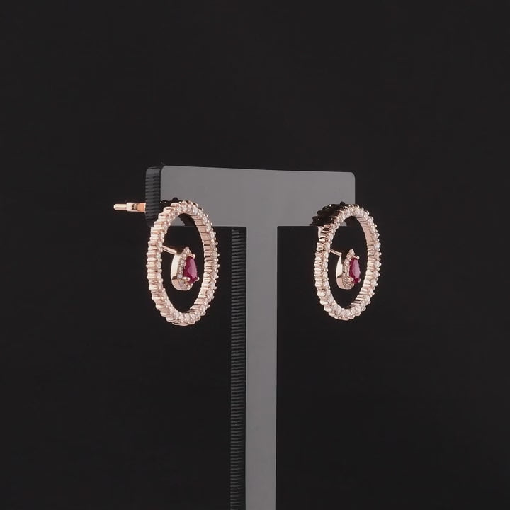 360 degree video of the ruby and natural diamond open circle earrings in 14K rose gold