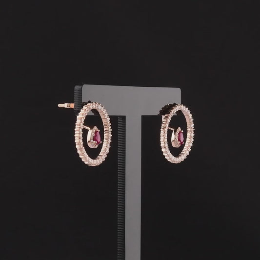 360 degree video of the ruby and natural diamond open circle earrings in 14K rose gold