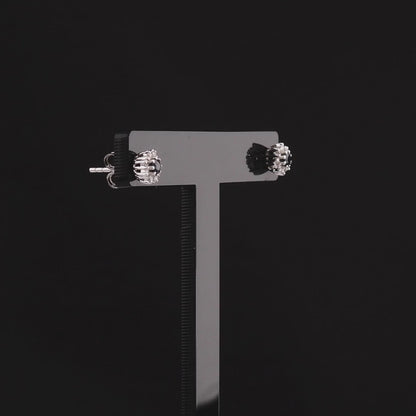 360 degree video of the sapphire and natural diamond halo stud earrings in 18K white gold