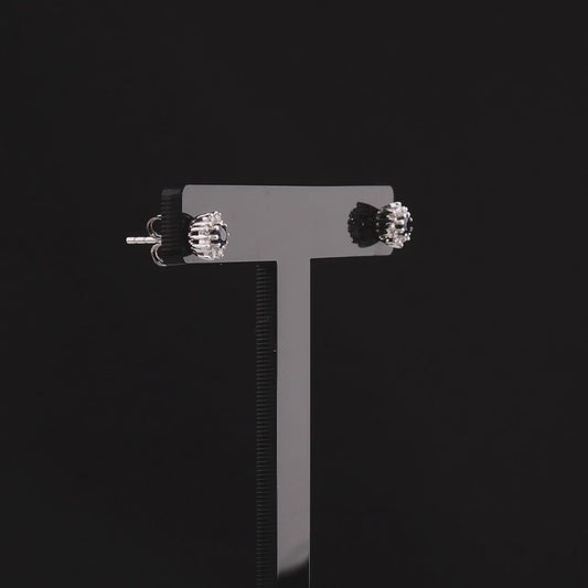 360 degree video of the sapphire and natural diamond halo stud earrings in 18K white gold