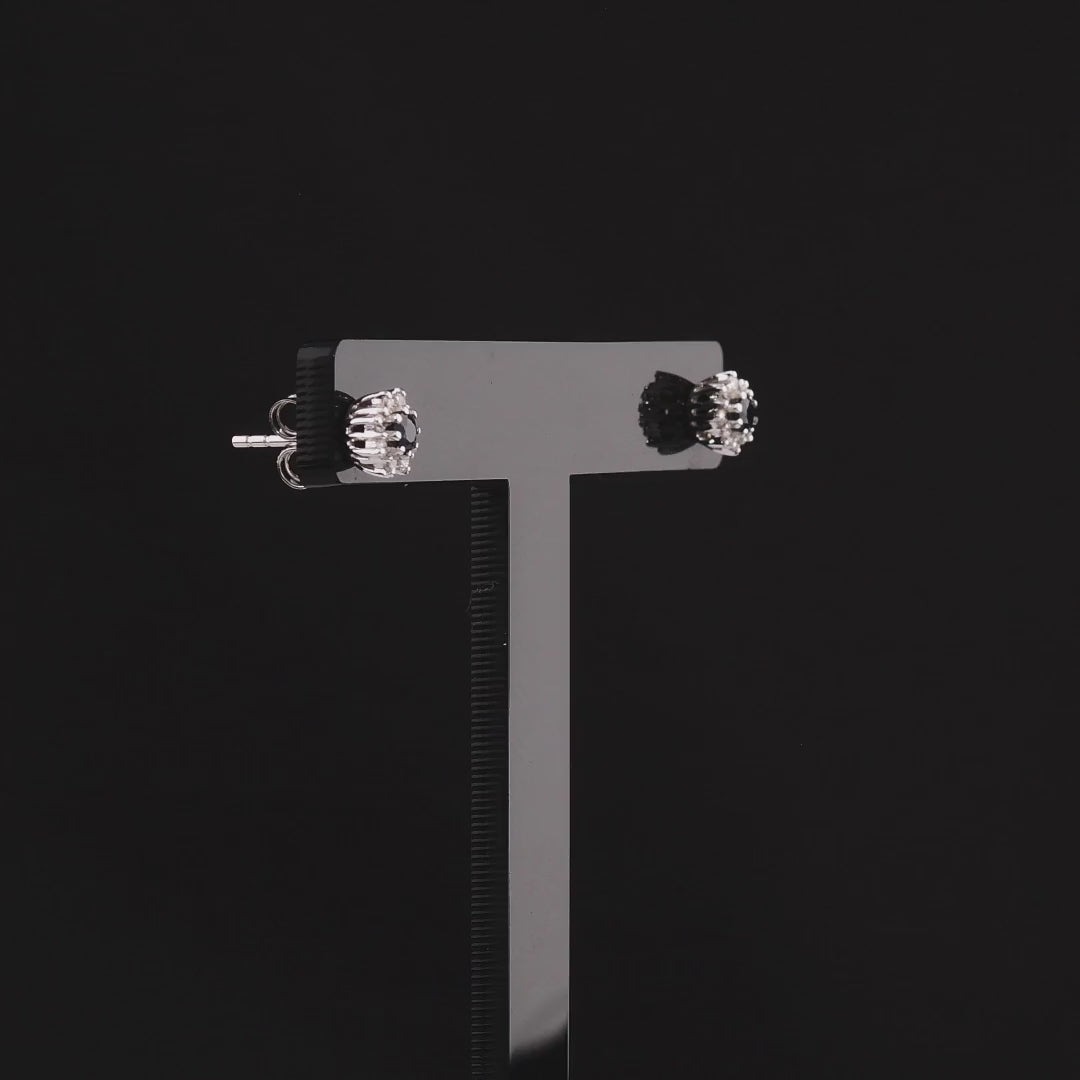 360 degree video of the sapphire and natural diamond halo stud earrings in 18K white gold