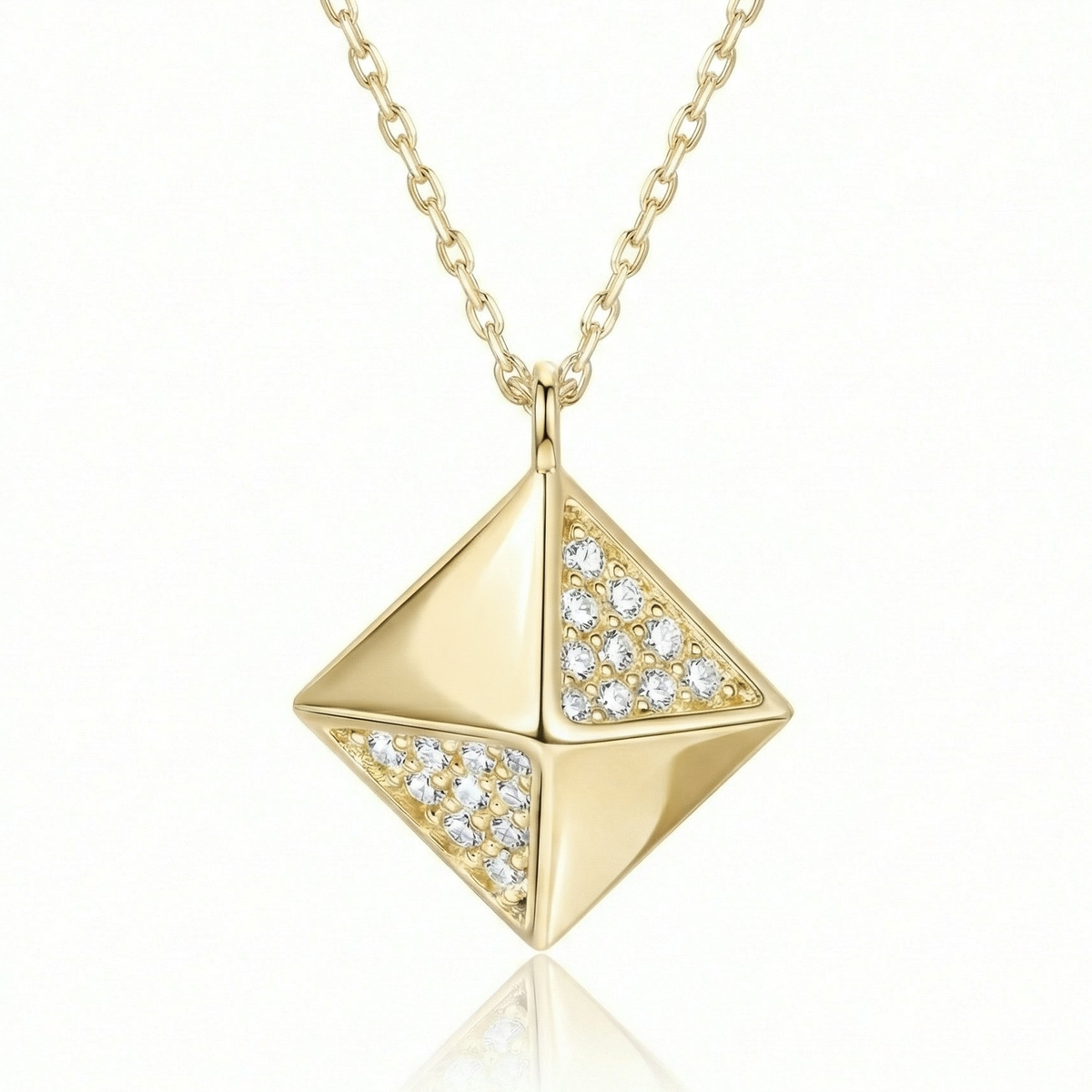 Pyramid pendant necklace in 14K solid gold, with small clear CZ stones set on two of its four faces.
