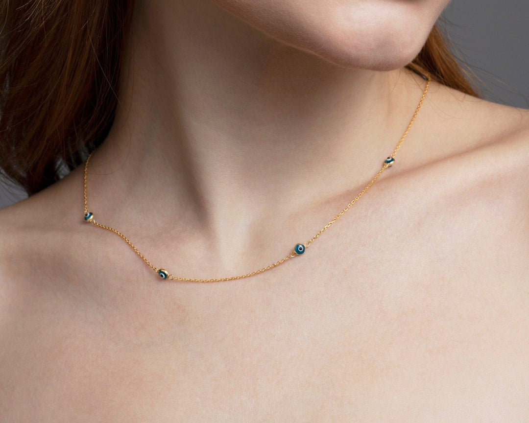 The Satellite Evil Eye Necklace Chain worn in 18K Gold Vermeil — refined accessory for women. Hypoallergenic, no green marks.