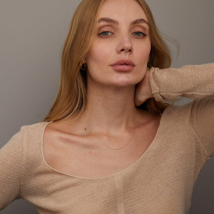 The Sideways Initial Necklace with Birthstone styled in 18K Gold Vermeil — elegant everyday jewelry. Hypoallergenic, no.