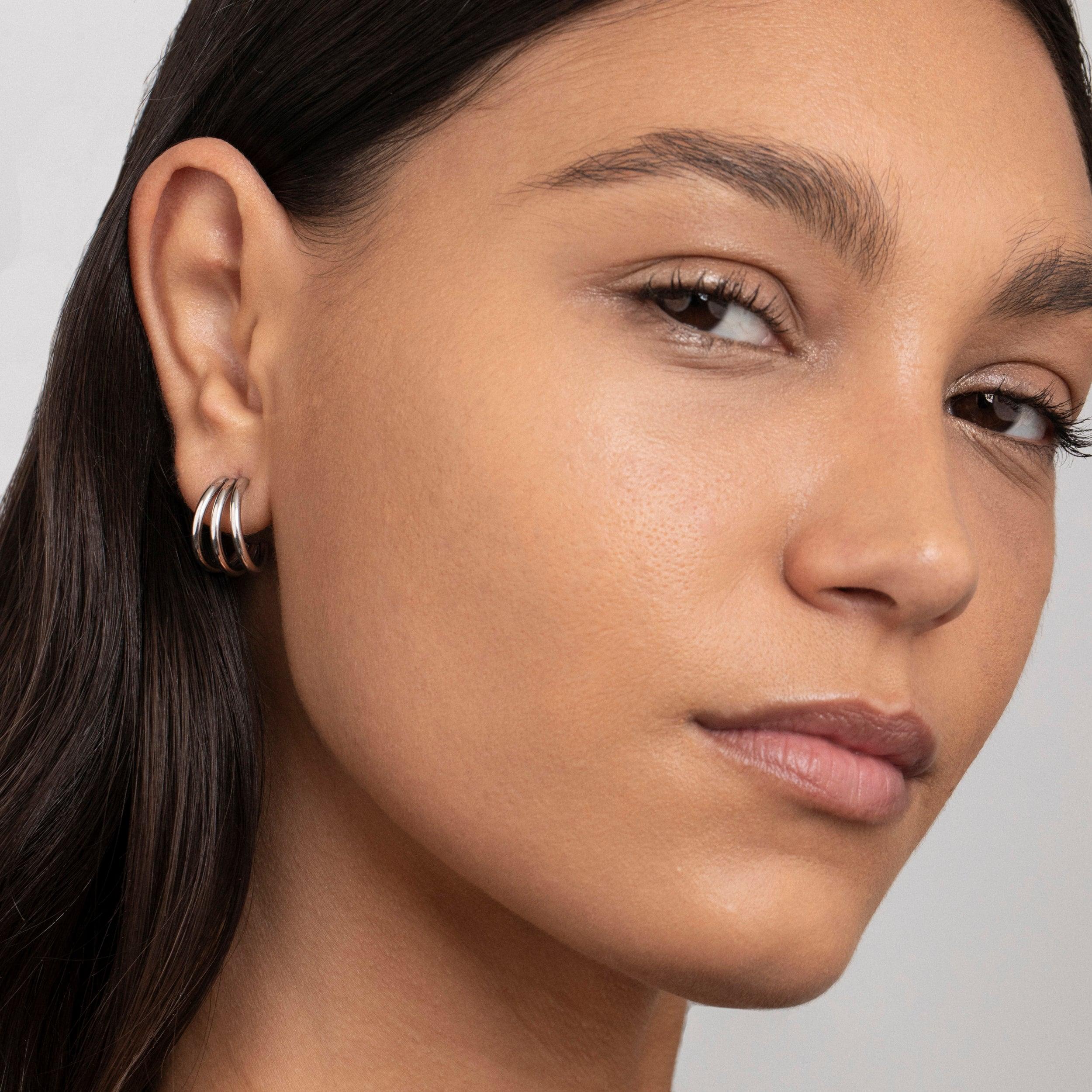 The Silver Triple Hoops styled in Stainless Steel — elegant everyday jewelry. Never tarnishes, waterproof.