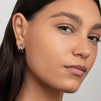 The Silver Triple Hoops styled in Stainless Steel — elegant everyday jewelry. Never tarnishes, waterproof.