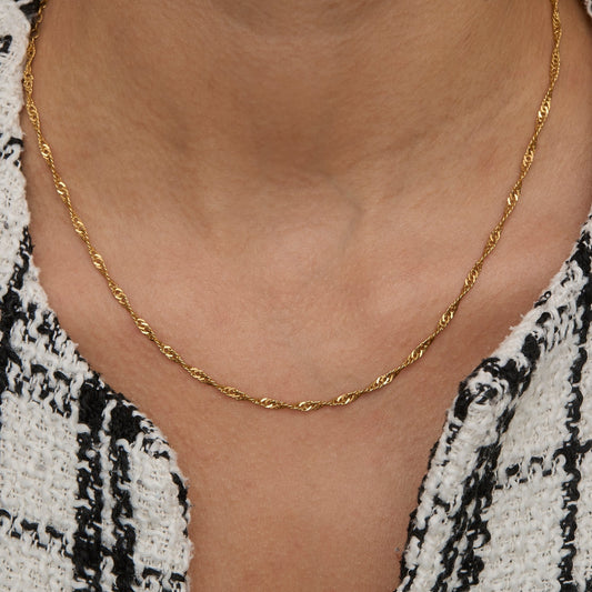 Gold Singapore chain necklace worn on the neck